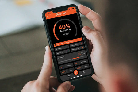 Roamer BMS SMART app in a man's hand.