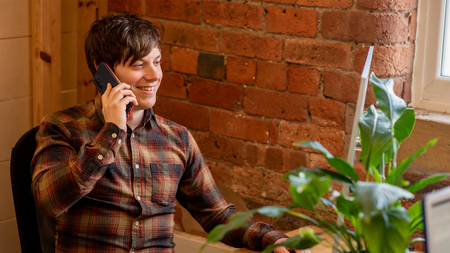 Chris from Roamer batteries on the phone in the Roamer office.