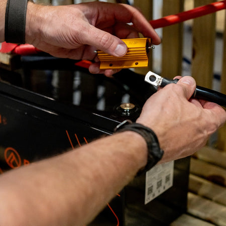 A member of the Roamer team connecting a Roamer lithium battery 