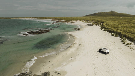 Roamer's Chewie campervan on a beach in Scotland