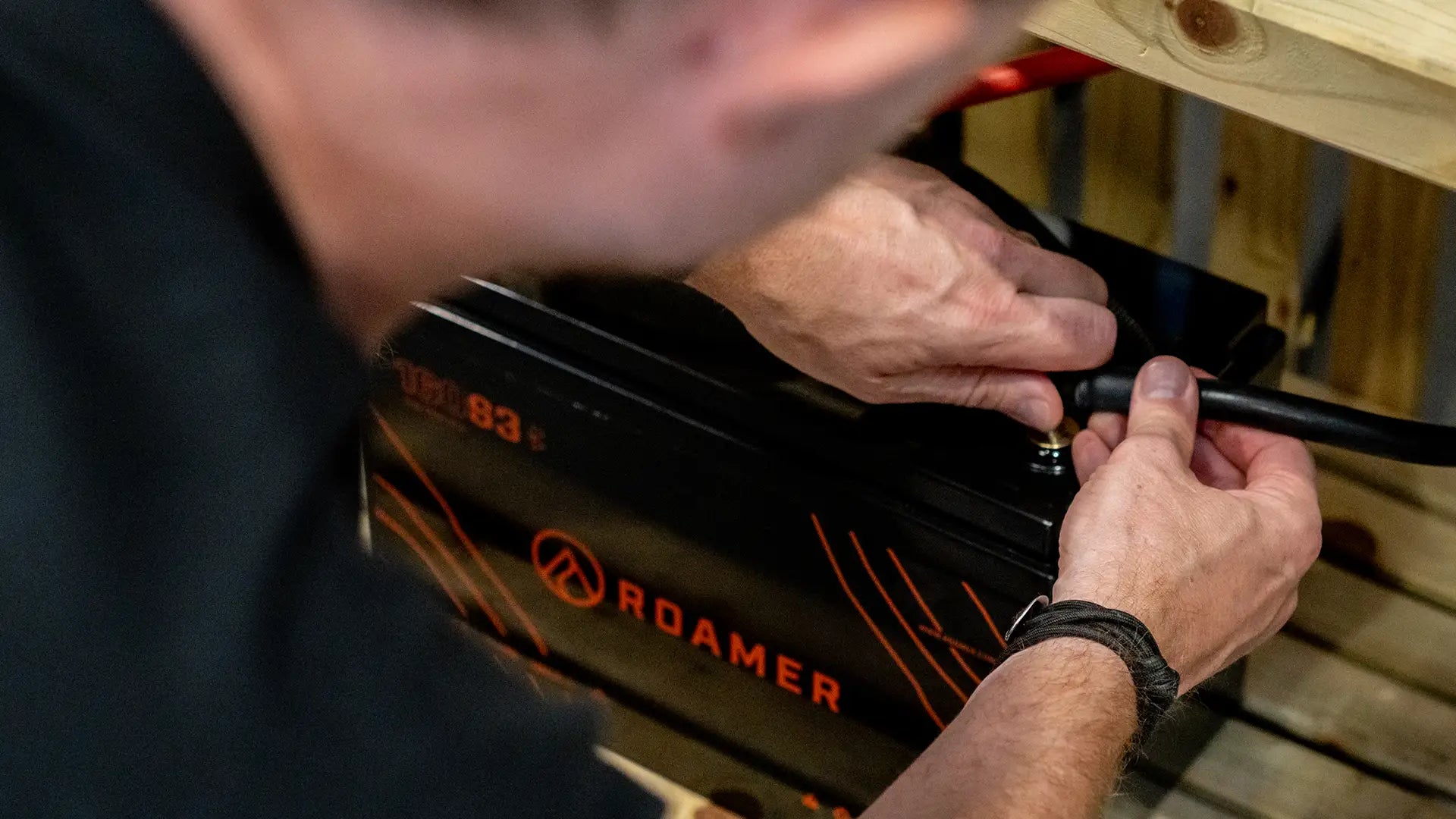 A roamer team member connecting a Roamer battery.