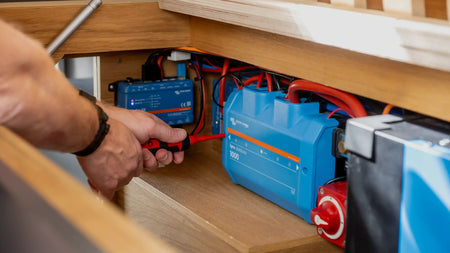 A member of the Roamer team fixing a Roamer and Victron electrical system