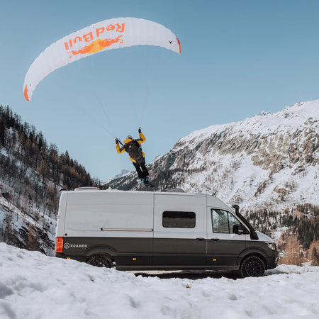 Professional speedrider Valentin Delluc performing a stunt over the top of Roamer's campervan Chewie.
